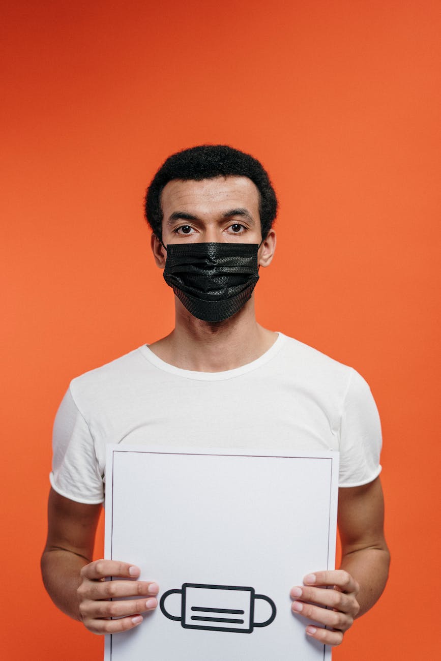 man in white crew neck t shirt wearing black face mask