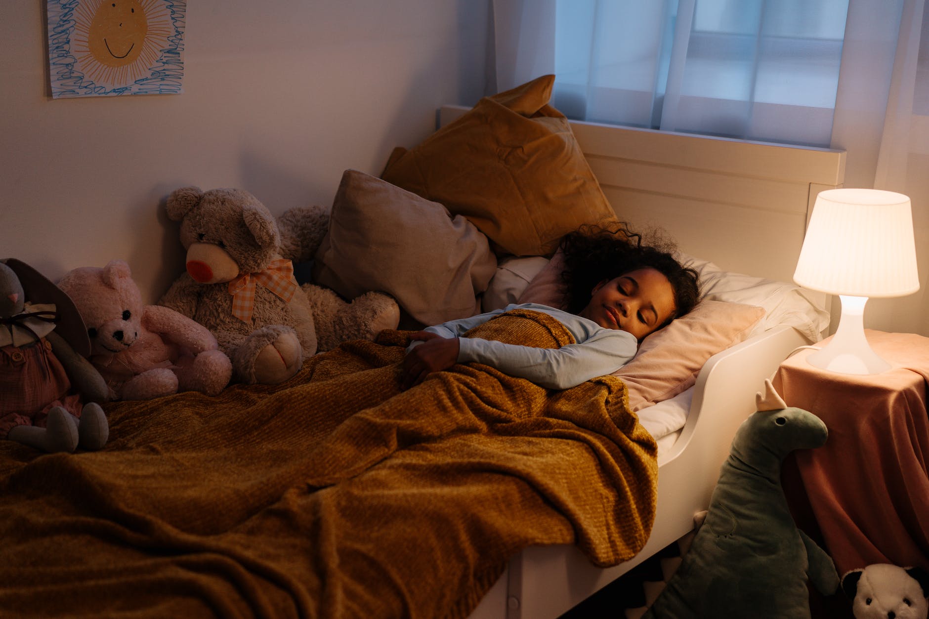 a young girl sleeping on the bed