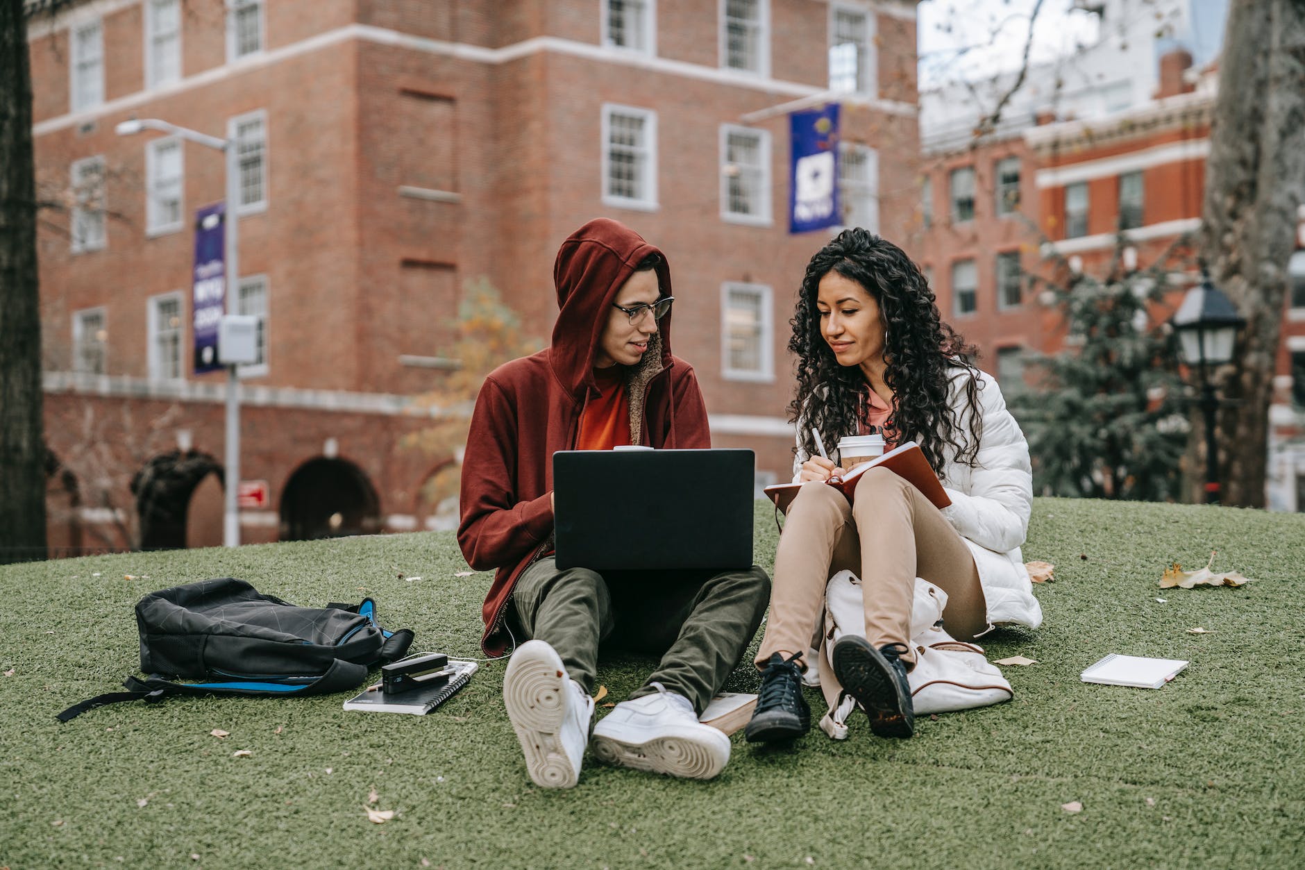 young students working on laptop while preparing for exam in campus