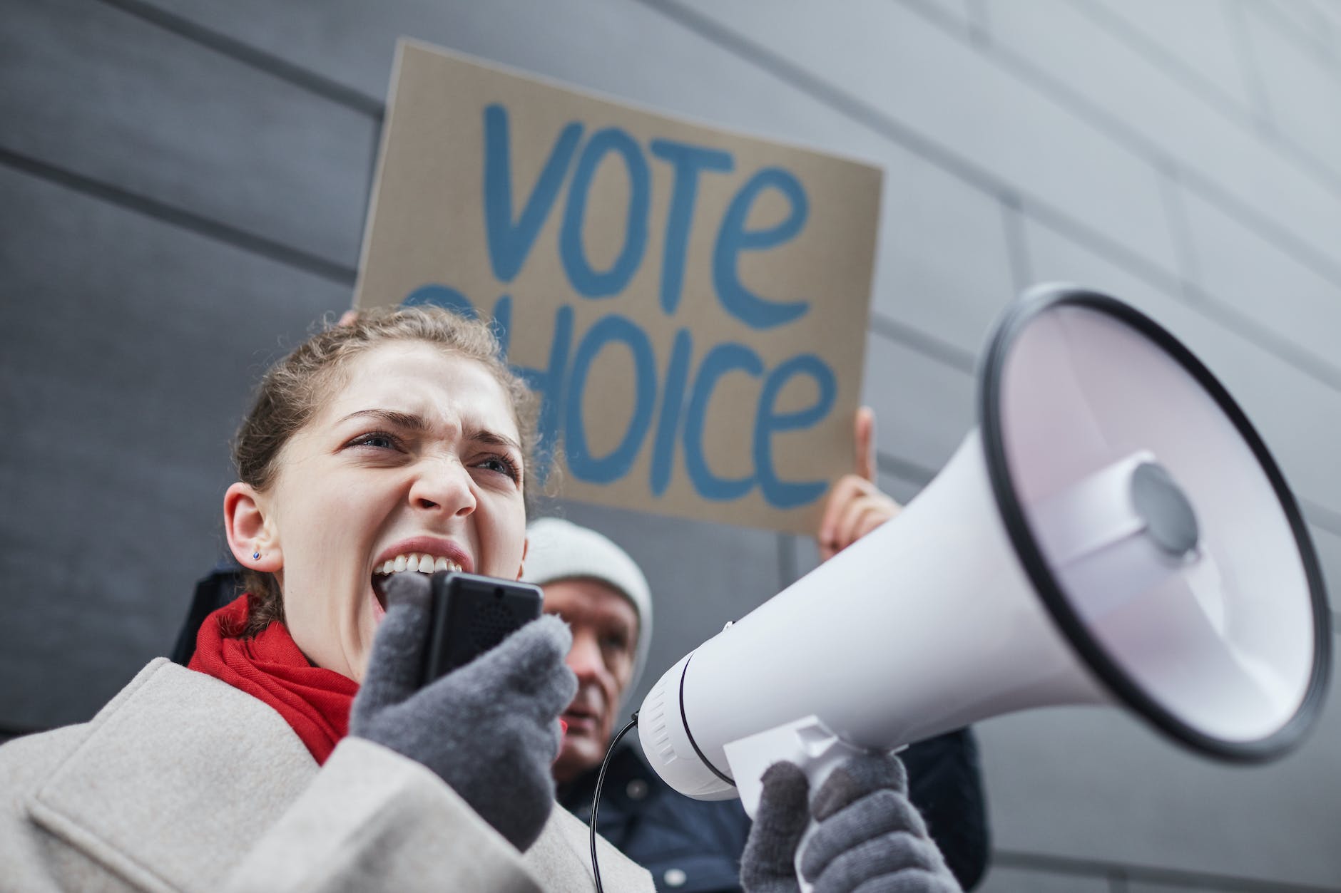 a woman speaking on a megaphone