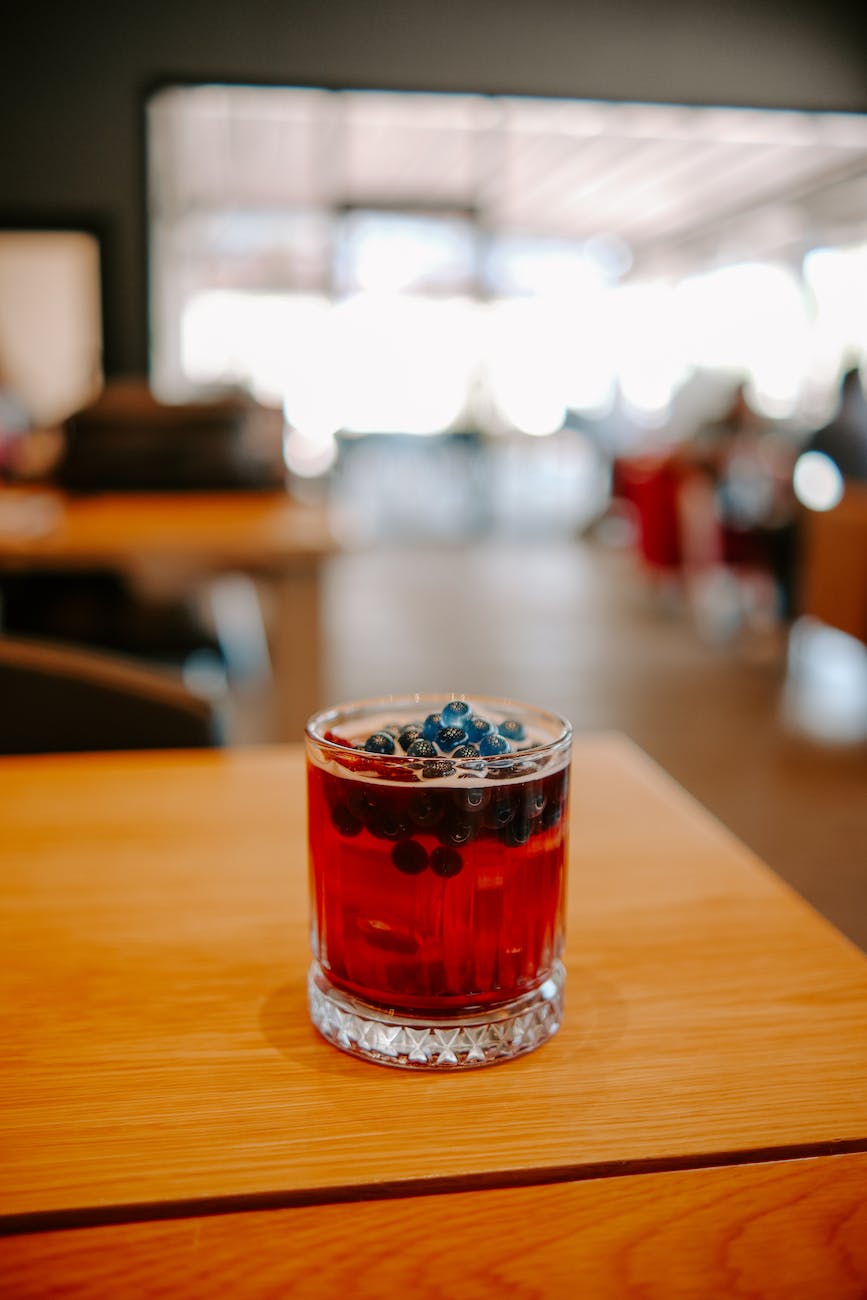 a drink with berries in a glass on the table