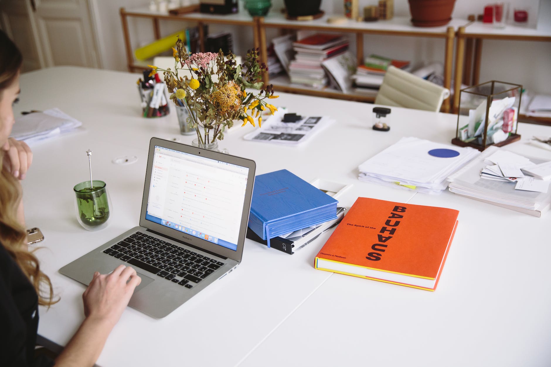 photo of orange book beside laptop