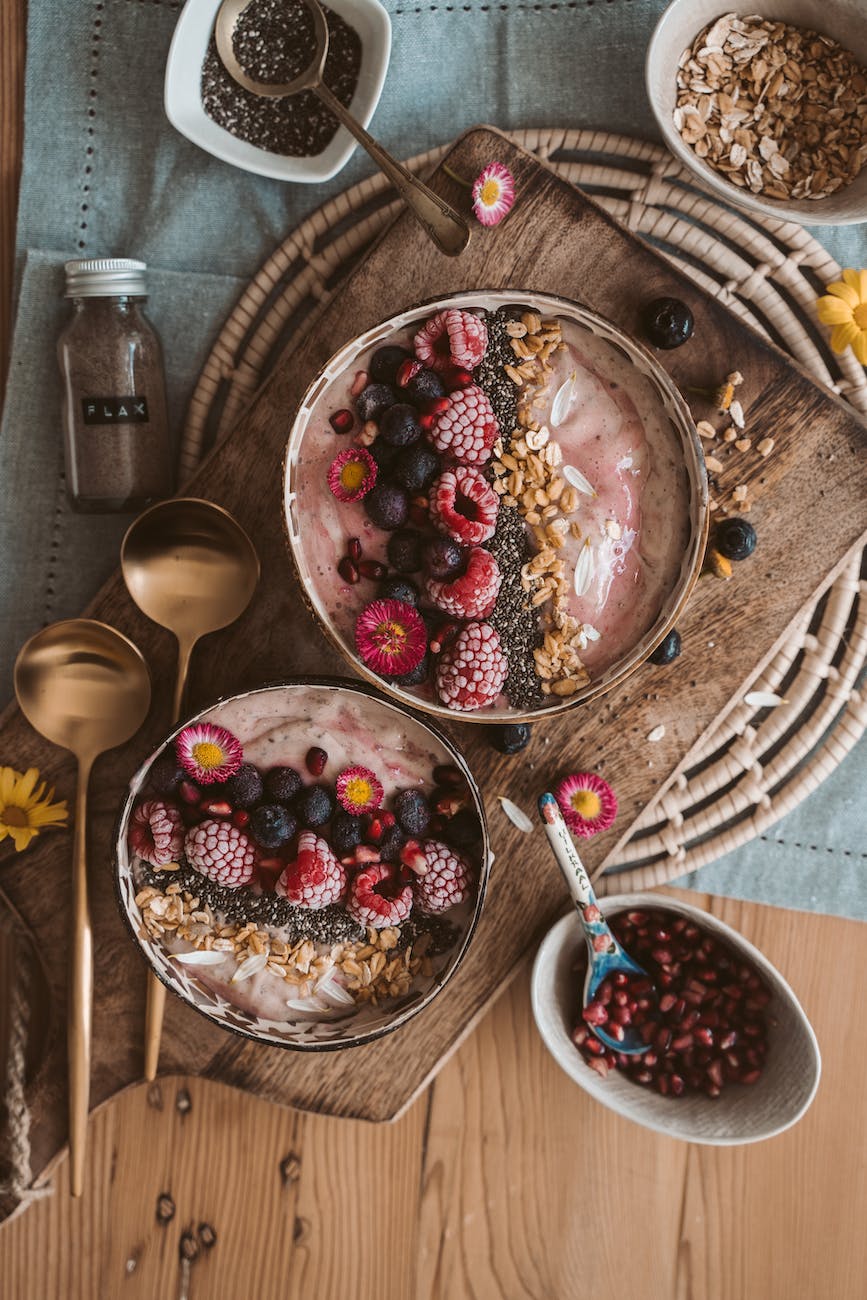 red and white round fruits on brown wooden bowl