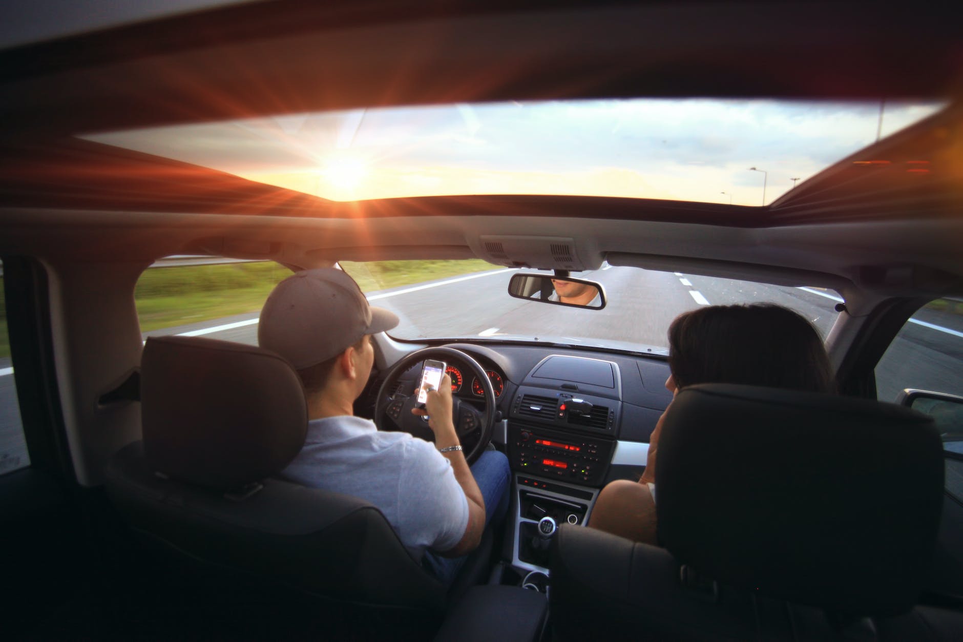 man using smartphone while driving